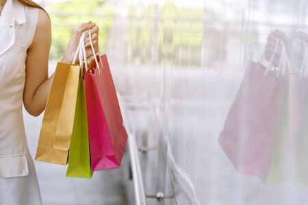 Shopaholic Women holding shopping bags ,money ,credit card person at shopping malls.Fashionable Woman love online website with sales tag on black Friday. E-commerce fashion digital marketing lifestyleの写真素材