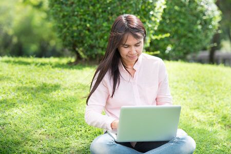 Work from home banner woman working on laptop outdoor at home cause of corona covid-19 virus world pandemic infection. Beautiful women connect internet outdoor working wireless internet technologyの写真素材