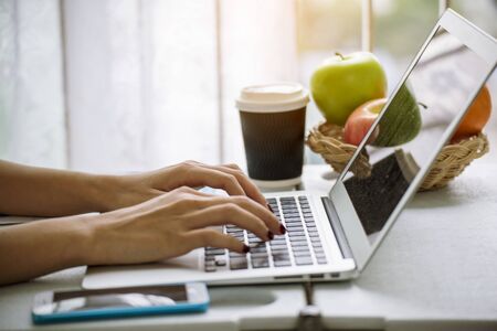 Work from home banner woman working on laptop outdoor at home cause of corona covid-19 virus world pandemic infection. Beautiful women connect internet outdoor working wireless internet technologyの写真素材