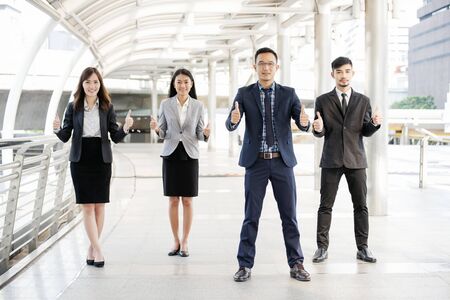 Asian diversity multicultural business corporate people group outdoor in modern city. Diversity coworkers team talking trust in partnership. Consultant colleague business people meeting conceptの写真素材