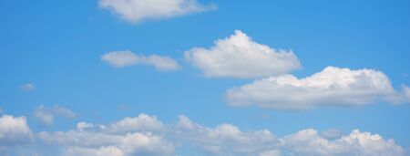 Panorama blue sky fluffy white cloud summertime on light sunny day cloudscape. Clear bright blue skyline sunlight climate panoramic background. Heaven blue environment ecology scenic nature backgroundの写真素材