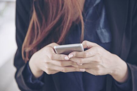 Woman using smartphone shopping online and call with technology lifestyle. Smiling face of asian woman holding cellphone with E-commerce Shopping online website Reading Online Article, Blog and vlog.の写真素材
