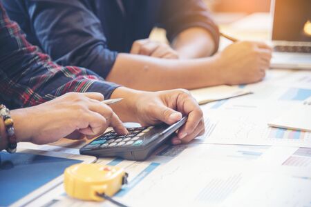 Businessman and building contractor are discussion using calculator to calculate interior design on site construction. Business Interior Conceptの写真素材