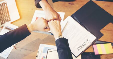 Team Business Partners Giving Fist Bump after complete a deal. Successful Teamwork Partnership in an office. Businessman with hands together. industry business concept.の写真素材