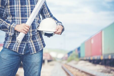 Civil Engineer Team holding blueprint plan for project on site working at railway track Manufacturing Industry Plant. Industry Engineering Concept.の写真素材