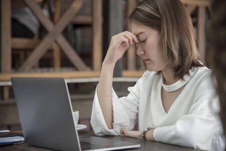 Woman nervous frightened to lost job infected corona covid-19 virus infectious.Working woman migraine headache sick from stress exhausted office syndrome  Economic crisis world epidemic infectionの写真素材