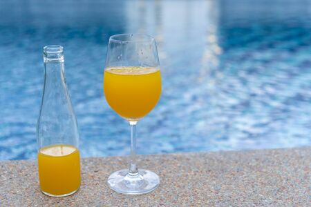 Orange juice on the swimming pool. Tropical Soft drink.の写真素材