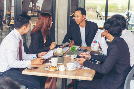 Business partner team meeting working together on office desk. Group of people diversity multiethnic teamwork collaboration communication. Business people team meeting together in conference room.の写真素材
