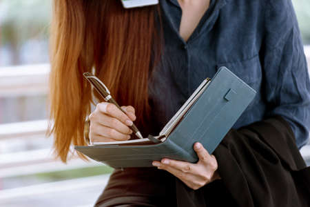Agenda of planner woman schedule and organize appointment 2020 Calendar Event. Smart Business woman note and schedule to set timetable organize schedule. Woman hands writing on Agenda.Timeline conceptの写真素材