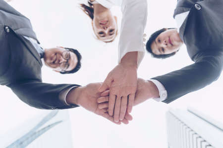 Teamwork Together Concept. Group of diversity people high five on air to greeting power of tag team. Multiethnic people group working togetherness. Volunteer collaboration in Business Team successの写真素材