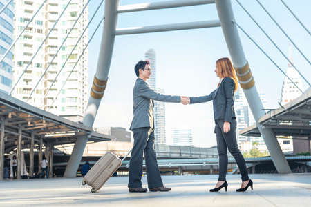 Team Business Partners shaking hands together to Greeting Start up new project. Shakehand Teamwork Partnership outside office modern city background. Businessman handshake together.  Business conceptの写真素材