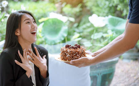Happy woman eat cake delicious sweet dessert in chocolate cafe. Sweet fancy cake got a surprise...