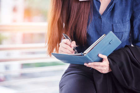 Agenda of planner woman schedule and organize appointment 2020 Calendar Event. Smart Business woman note and schedule to set timetable organize schedule. Woman hands writing on Agenda.Timeline conceptの写真素材