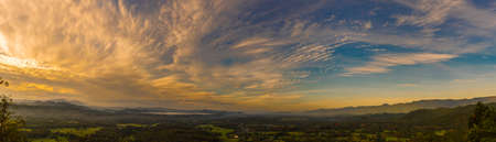 Panorama summer sunset golden cloud summertime light sunny day cloudscape mountain scene. Panoramic...