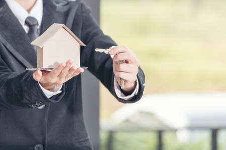 Real estate agent showing new house and bank note from Saving account for home insurance. real estate conceptの写真素材