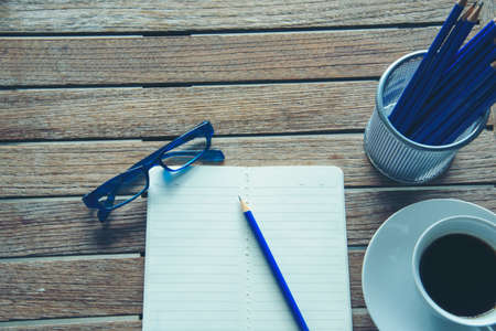 Office laptop business financial document chart and graph on wooden table with coffee cup. Flat lay notebook computer laptop on office desk. No people business graph chart mockup on business workspaceの写真素材