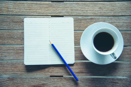 Office laptop business financial document chart and graph on wooden table with coffee cup. Flat lay notebook computer laptop on office desk. No people business graph chart mockup on business workspaceの写真素材