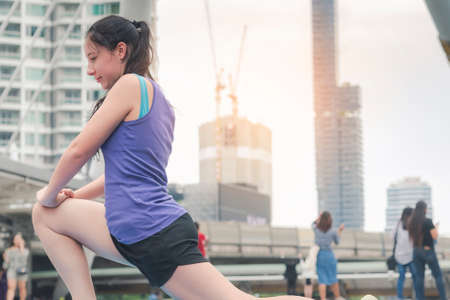Sport Fitness Women running exercise in modern city wear wellness sportswear outside. Young woman...