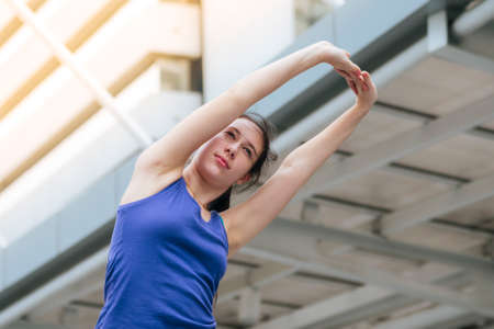 Sport Fitness Women running exercise in modern city wear wellness sportswear outside. Young woman...