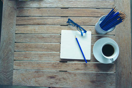 Office laptop business financial document chart and graph on wooden table with coffee cup. Flat lay notebook computer laptop on office desk. No people business graph chart mockup on business workspaceの写真素材