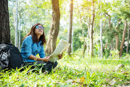 Happy hipster asian tourist travel in Asia backpack with smiling face and happiness laugh. Beautiful woman backpack around the word. Young traveller concept. Young traveller lifestyleの写真素材