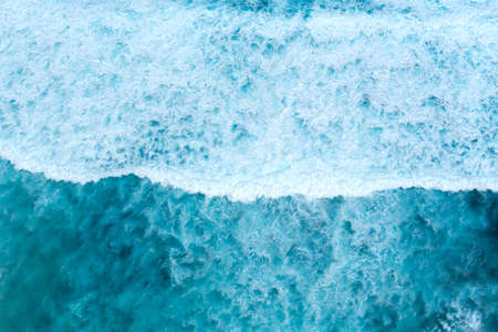 Summer tropical beach white sand blue sea summertime on sunny day. Sea coast beach scenery foamy wave on the beach waves of blue sea tropical ocean sand. Travel holidays vacation seaside turquoise .の写真素材