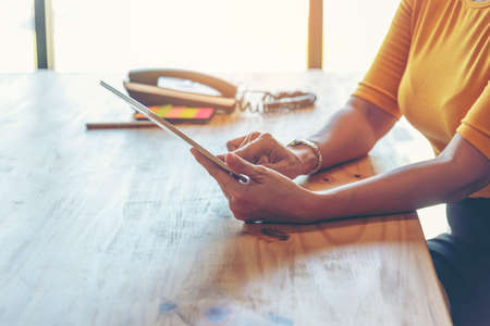 Young start up business woman working enjoy good news from smartphone. Asian Business people working at home office with happinessの写真素材