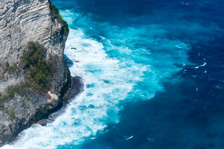 Summer tropical beach white sand blue sea summertime on sunny day. Sea coast beach scenery foamy wave on the beach waves of blue sea tropical ocean sand. Travel holidays vacation seaside turquoise .の写真素材