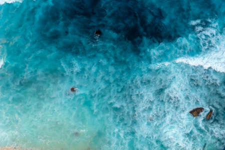 Summer tropical beach white sand blue sea summertime on sunny day. Sea coast beach scenery foamy wave on the beach waves of blue sea tropical ocean sand. Travel holidays vacation seaside turquoise .の写真素材