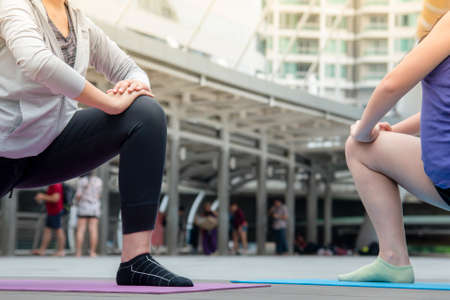 Sport Fitness Women running exercise in modern city wear wellness sportswear outside. Young woman workout outdoor exercising on bright sunny outside. Healthy wellness lifestyle woman concept.の写真素材