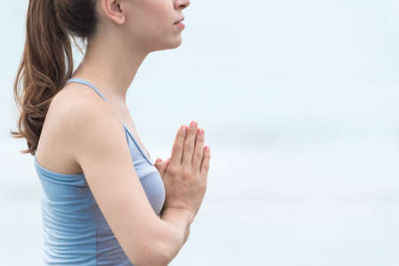 Yoga fitness lifestyle healthy woman relaxation doing a meditation. Yoga meditating outdoor with zen on sitting position. Young exercise concept.の写真素材
