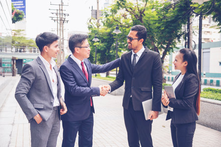 Sustainable Partner trust mission of ecosystem plant business holding green plant together symbolism of green business company with development ecology concept. Sustaining partner trust hands togetherの写真素材