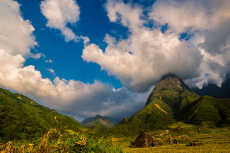 Beautiful landscape mountain green field grass meadow white cloud blue sky on sunny day. Majestic green scenery big mountain hill cloudscape valley panorama view in countryside greenery pastureの写真素材