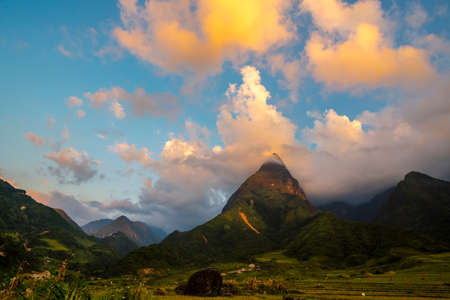Beautiful landscape mountain green field grass meadow white cloud blue sky on sunny day. Majestic green scenery big mountain hill cloudscape valley panorama view in countryside greenery pastureの写真素材