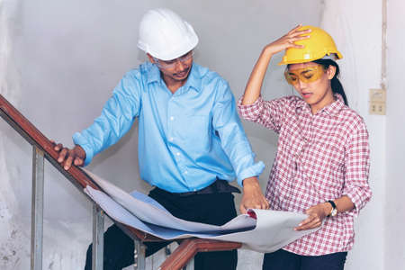 Construction engineer teamwork Safety Suit Trust Team Holding White Yellow Safety hard hat Security...