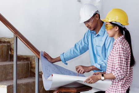 Construction engineer teamwork Safety Suit Trust Team Holding White Yellow Safety hard hat Security...