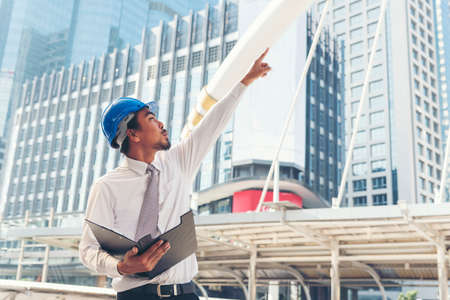 Engineer man hands holding hardhat white work helmet hard hat for Civil Construction Engineering....