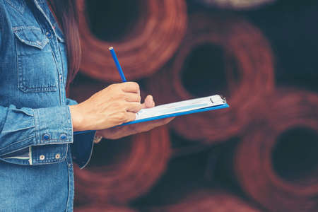 Woman construction engineer wear safety white hard hat at construction site industry worker. Female engineer worker civil engineering with hard hat safety helmet. Woman construction Engineer conceptの写真素材