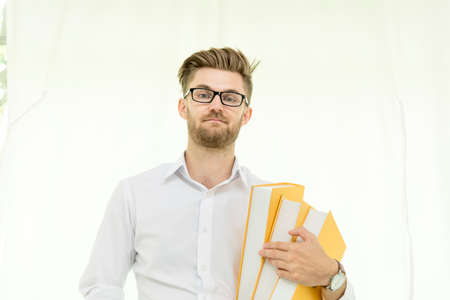 Caucasian man holding text book study hard surprise in content. education conceptの写真素材