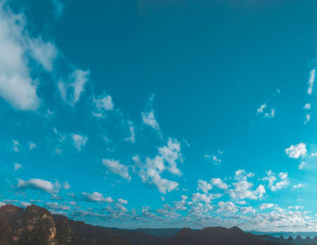 Blue sky fluffy white clouds on summer season bright clear skyline with beautiful cloudscape. Panorama blue sky clouds pattern on daylight with copy space. Cumulus cloudscape air climate sunny dayの写真素材