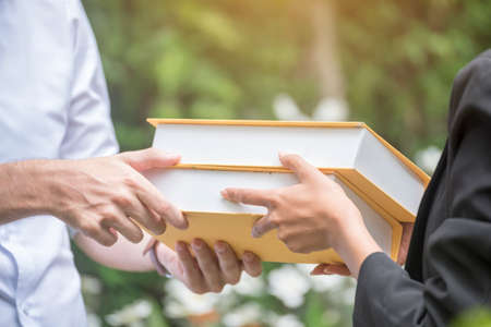 Young student collage holding stack of book together. Student life try to get a better grade by reading a book. learning knowledge study concept.の写真素材