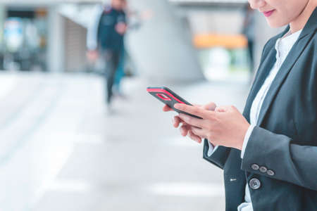 Business woman using smartphone shopping online, call, texting message internet technology lifestyle. Asian woman using cellphone walking on city street. Smart phone smart confident woman modern cityの写真素材