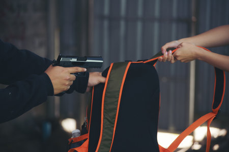 Thief armed man rob woman by gun on street so scared shocked face. Frightened asian woman was rob...