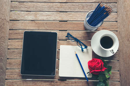 Top view office desk laptop and coffee cup on wood table copy space. Tabletop notebook laptop coffee cup for officer display empty space on wooden background. Home business work from home workspaceの写真素材
