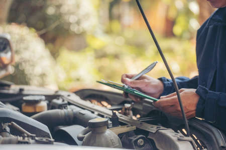 Mechanic car service auto garage in automotive mobile center. Technician workshop repair engine motor vehicles service mechanical engineering business. Automobile mechanic hands car repairs technicの写真素材