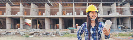 Banner Woman construction engineer hold blueprint wear plaid shirt safety white hard hat at...