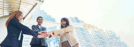 Banner Partners hands together teamwork group of business people meeting in firm company office. Panorama Diversity Hands join empower partner teams connection Mergers acquisitions social communityの写真素材