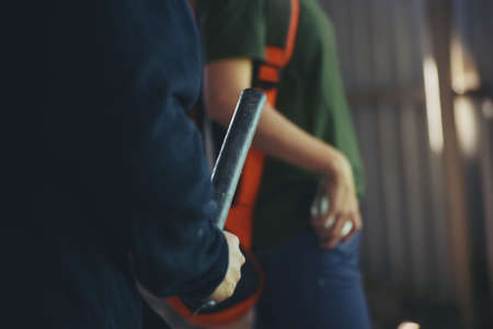 Thief armed man rob woman by baton on street stalker behind young woman back. Woman on phone careless stalker sneaking to steal, rob aggressive by danger bandit. Thief using baton nightstick weapon.の写真素材