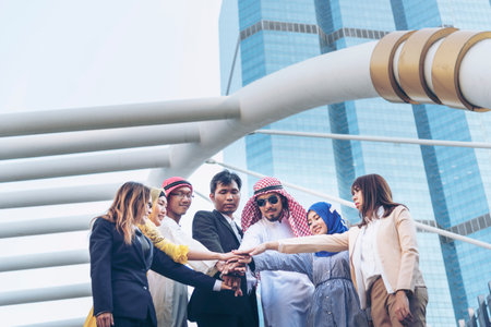 Happy Diverse multiethnic Partners hands together. Teamwork group of multi racial smile people meeting join hands togetherness. Diversity people joining empower partnership teams volunteer connectionの写真素材