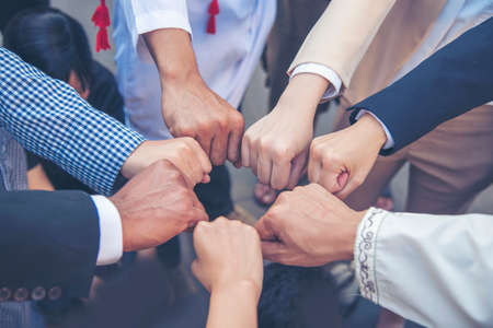 Diverse multiethnic Partners hands together teamwork group of multi racial people meeting join hands togetherness. Diversity people hands join empower partnership teams connection volunteer communityの写真素材